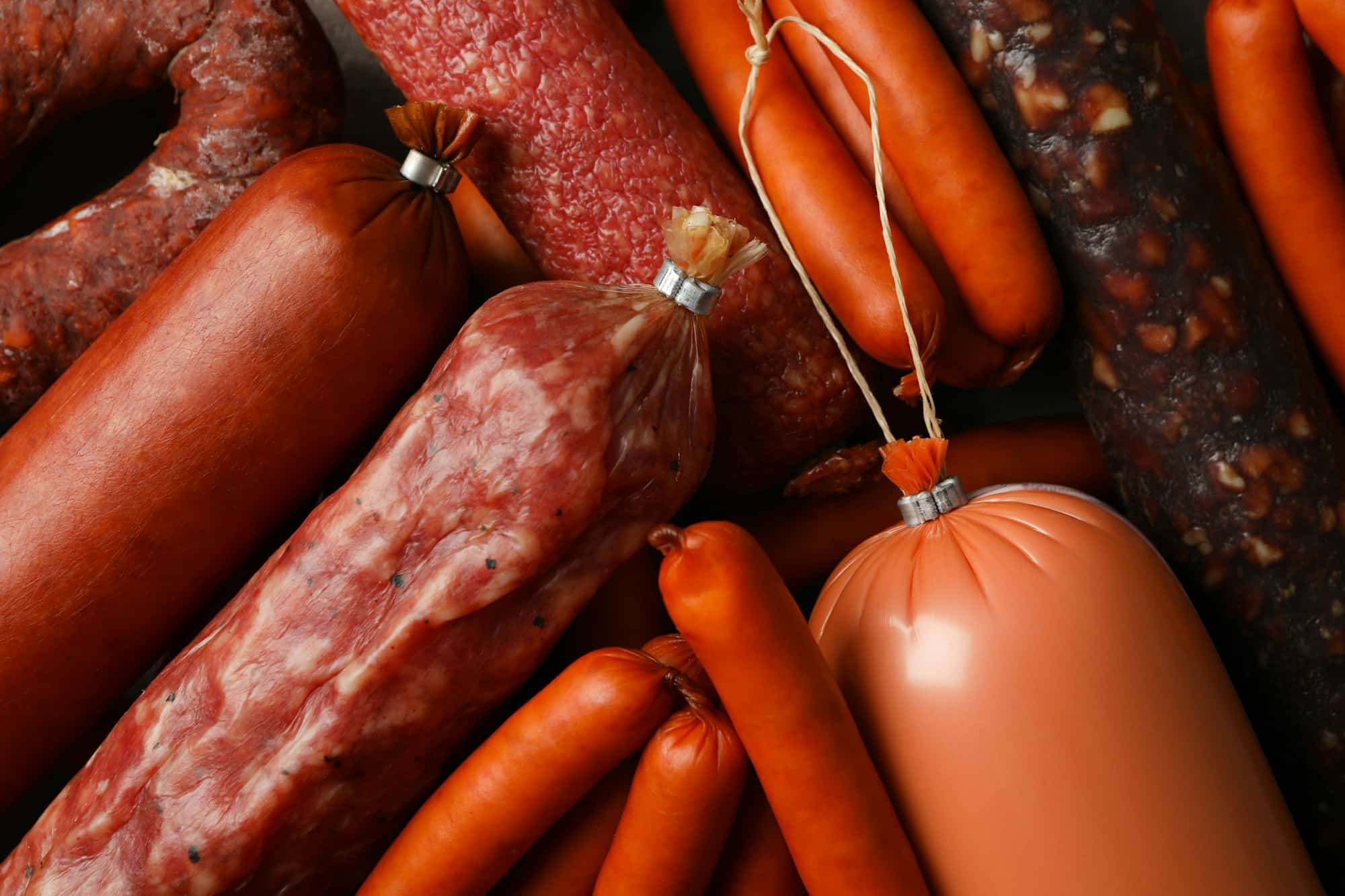 Delicious different sausages texture background, close up